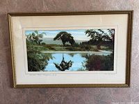 Front view shows full framed photograph with title and landscape image