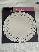 Front of sealed package showing one 14.5" doily and quantity 4