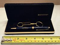 Entire gift set in open case showing pen, key ring, Bankers logo and tape for scale