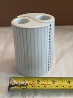 Pair assembled into full cylinder under tape measure showing height ~4.75 in