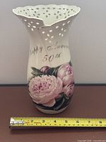 Front view showing text, floral design, rim detail, width reference
