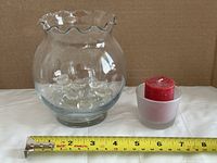 glass bowl with gems, votive holder and candle, tape measure for scale