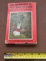 Front cover with dust jacket and measuring tape for scale