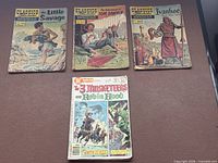 Four comic books laid out showing front covers