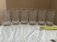 All six etched Cornflower tumblers lined up with tape for scale