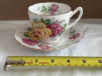 Cup on saucer with tape measure for scale