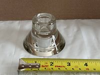 Overall view of clear glass candle holder with tape measure showing base diameter ~3.25 in.