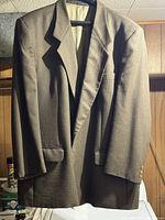 Full view of front of blazer on hanger showing overall style and lapel