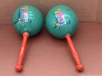Front view of both maracas showing painted design