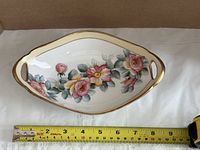 top view showing floral pattern, handles and ruler for length