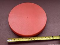 Top view of orange disc with measuring tape showing 11 in. diameter