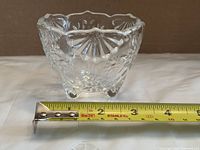 Full view of the candy bowl beside tape measure showing diameter