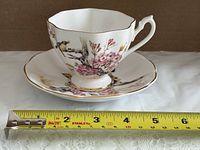 Teacup and saucer side view with measuring tape