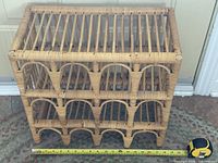 Front view showing two rows of four arched bottle slots and tape measure for width