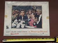 Full view of framed lobby card with tape measure for scale