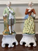 Front view of both figurines side by side