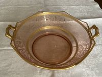 Top view of pink depression glass bowl showing etched pattern and gold bands