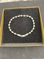 Full view of twisted sterling silver bracelet in presentation box