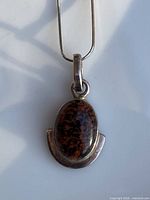 Front view of pendant on snake chain