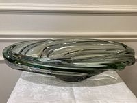Top angled view showing spiral form and green-cased clear glass