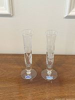 Two etched glass bud vases front view showing floral design and labels