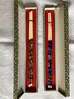 Two chopstick pairs in open fabric cases