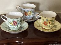 All three teacup and saucer sets displayed