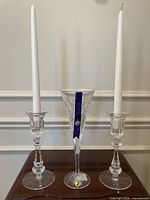 Full view of both candlesticks with candles inserted and central champagne flute
