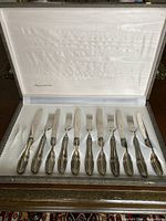Open presentation case displaying knives and forks