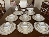 Full 42-piece Wedgwood Whitehall china set laid out on table
