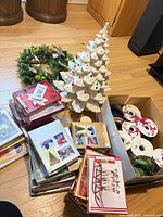 Overall lot showing ceramic tree, wreath, boxed cards and ribbons