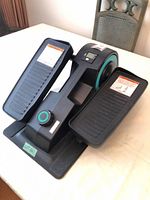 Overall view of Cubii under-desk elliptical showing pedals, resistance dial and display