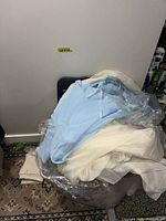 Pile of folded blue and white curtains in plastic bag