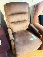 Front view of upholstered manual recliner chair with wood arm frames