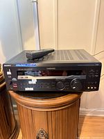 Front and top of Sony STR-DE945 receiver with remote resting on unit