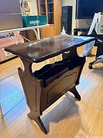 Full view of dark brown wooden magazine rack table