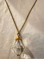 Close view of crystal pendant and portion of chain