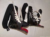 Full view of both Bauer NS skates with blade guards attached