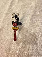 Front view of Mickey Mouse pin showing full design and text