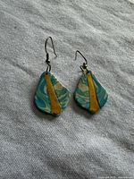 Front view of the pair showing swirl pattern and gold stripe