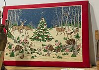 Front view of entire fabric wall art showing winter scene and red border