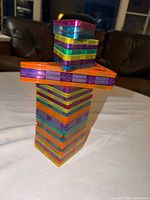 Stacked tower of colourful magnetic tiles showing variety of colours and quantities