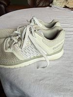 Side view of pair showing Reebok branding, knit upper, and sole