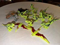 Group shot of all dinosaur figures on table