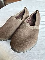 Oblique view of both shoes showing suede uppers and overall condition