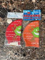 Front view of both packaged swim caps showing brand header, colors and design