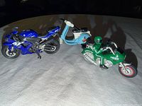 Front view of three toy motorcycles on table