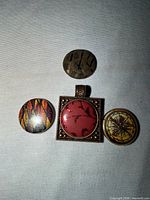 Pendant with red bird insert, three additional inserts shown