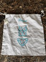 Full view of white embroidered lingerie bag