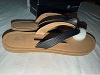 Side profile of both sandals showing strap design and box